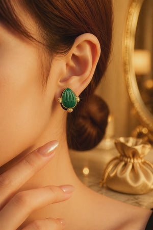 Earring with carved stone with black enamel