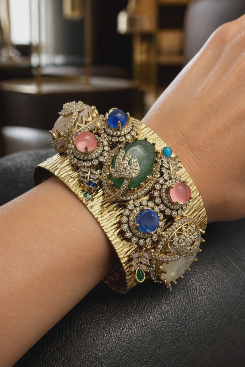 Gold textured ethnic cuff bracelet with coloured stones and AD detailing in traditional designer style