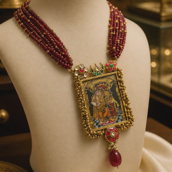 Miniature painting necklace with Radha Krishna artwork, kundan crystal detailing, and ruby quartz bead strands in traditional ethnic style