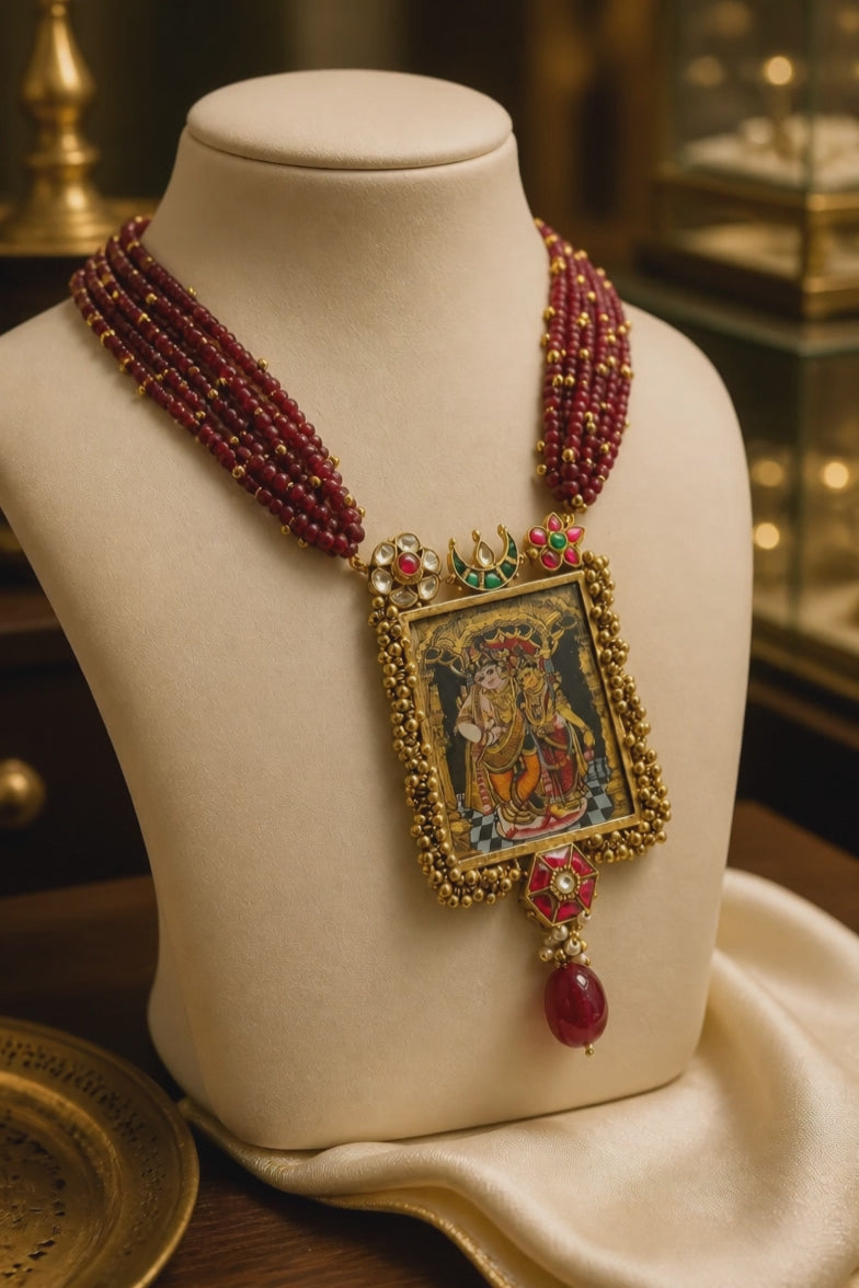 Miniature painting necklace with Radha Krishna artwork, kundan crystal detailing, and ruby quartz bead strands in traditional ethnic style
