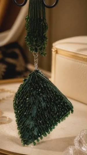 Luxury green beaded wristlet bag with intricate handcrafted beadwork and contemporary triangular design