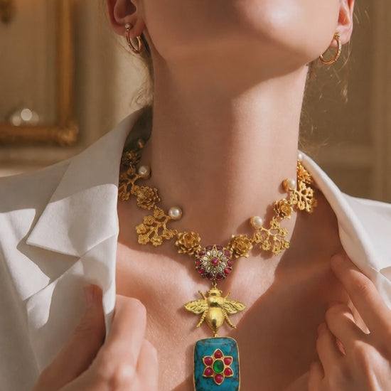 Designer bug motif necklace with turquoise pendant and intricate gold detailing in artistic ethnic jewellery style
