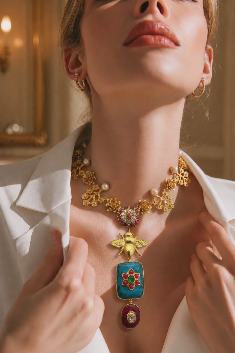 Designer bug motif necklace with turquoise pendant and intricate gold detailing in artistic ethnic jewellery style