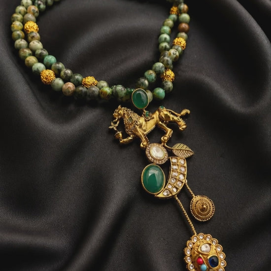 Designer lion motif necklace with kundan crystal detailing and greenish turquoise bead strands in traditional ethnic jewellery style