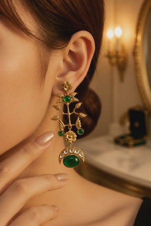 Gold earring with kundan detailing and green onyx stones