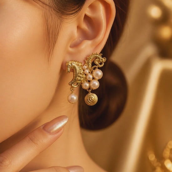 Traditional gold horse motif earrings with shell pearl detailing and intricate ethnic design