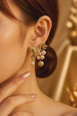 Traditional gold horse motif earrings with shell pearl detailing and intricate ethnic design