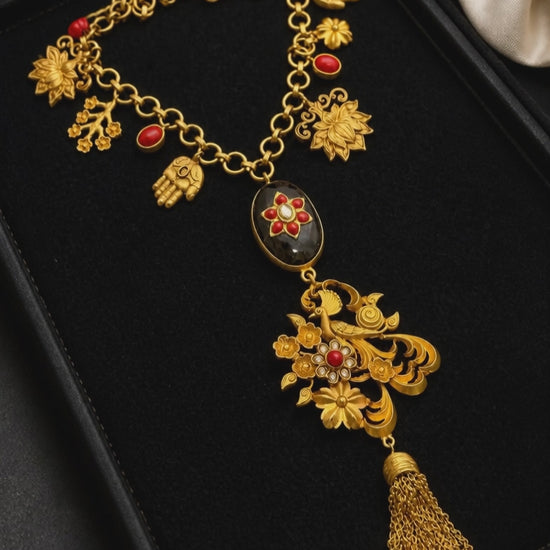 Designer charms style necklace with coral detailing and tassel pendant in traditional ethnic jewellery style