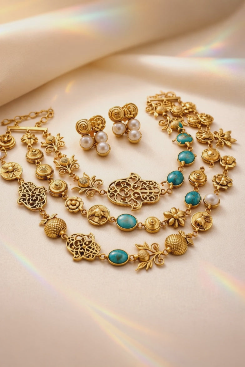 Antique gold layered necklace set with turquoise stones, floral motifs, heritage charms, and matching stud earrings displayed on a jewellery bust
