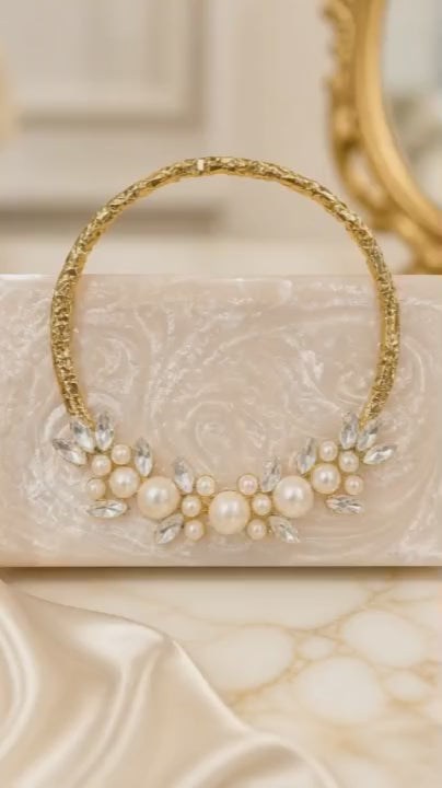 Luxury crystal bunch handle bag with pearl and crystal embellished gold handle and marble finish clutch body