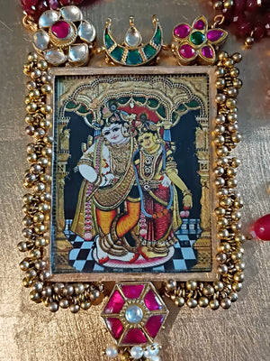 Decorative Radha Krishna frame with intricate design and colorful embellishments on a gold background